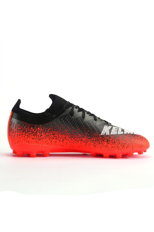 A pair of Kelme Lava Football Boots with a gradient color change from black to red, featuring a sock-like fit and brand logo on the side.